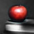 Red apple on top of black and white books